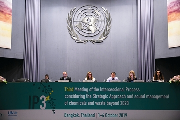  A group of people sitting on a panel indicating that it is the 2020 SAICM confernce in Bangkok. A United Nations Emblem is in the back 
