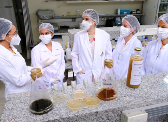 five women in protective clothes chatting in a labor.