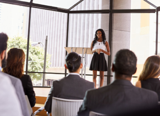 Young black businesswoman presenting seminar to an audience