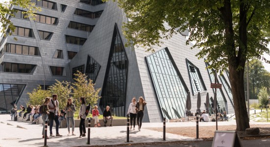 The Leuphana Campus building with students outdoors