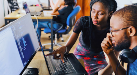 Woman shows man something on a Computer Screen