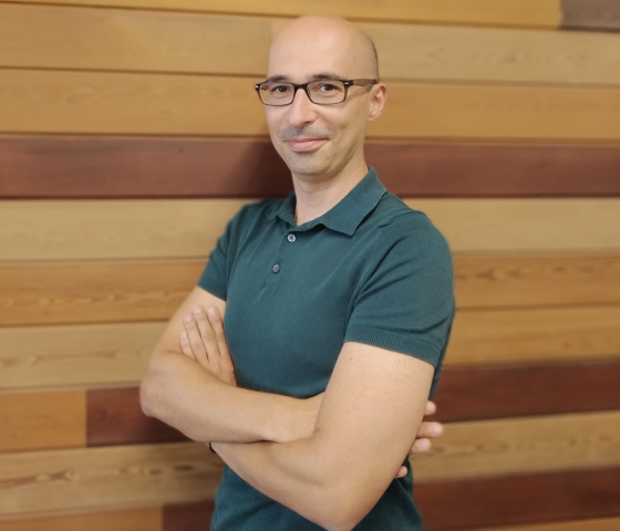 a man with a green poloshirt looking at the camera