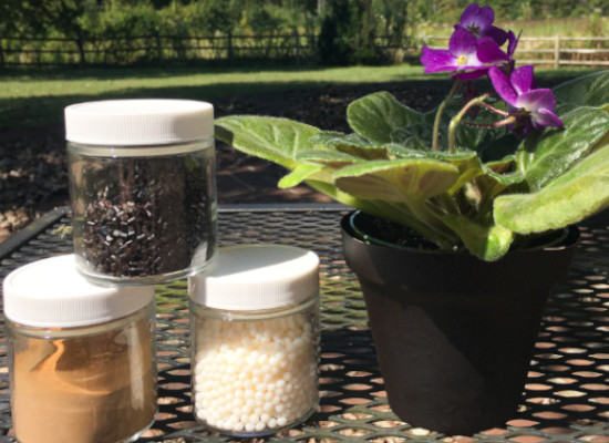 three container with different pellets next to a flower pot.