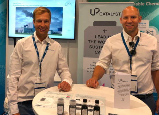 two men smiling at a booth