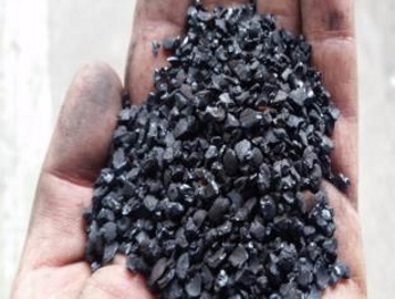 a hand holding biochar