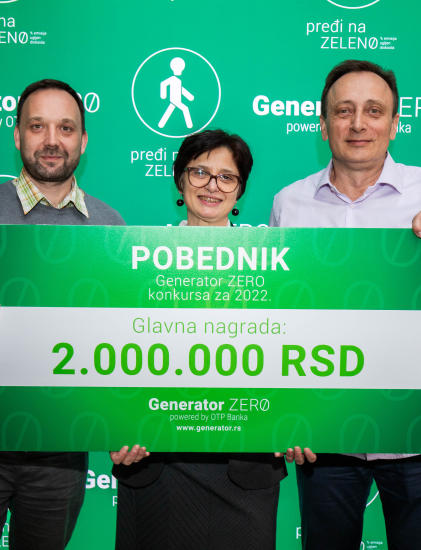 a woman and two men holding a giant cardboard indicating they won the 2000000 RSD prize money for the Generator ZERO competition