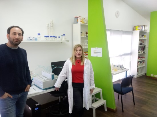 a man and a woman in a labcoat standing in a laboratory