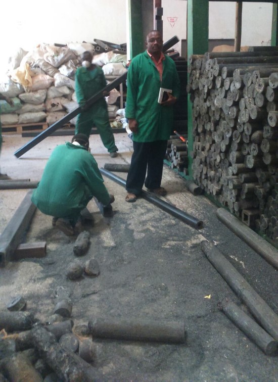 three men standing in a workshop