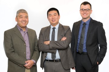 three men smiling at the camera