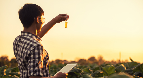  man on a field with a tablet and a liquid in his hand 