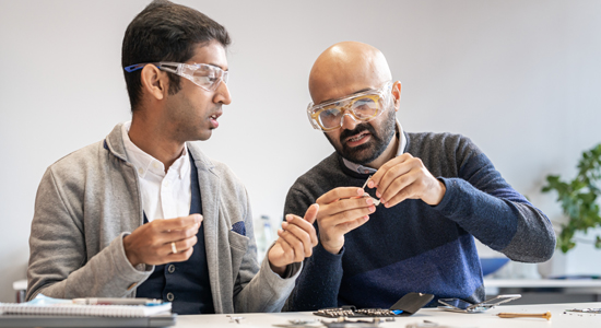 Two Technicians repairing a Smart Phone