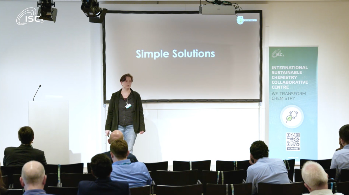 Woman presenting on front of audience