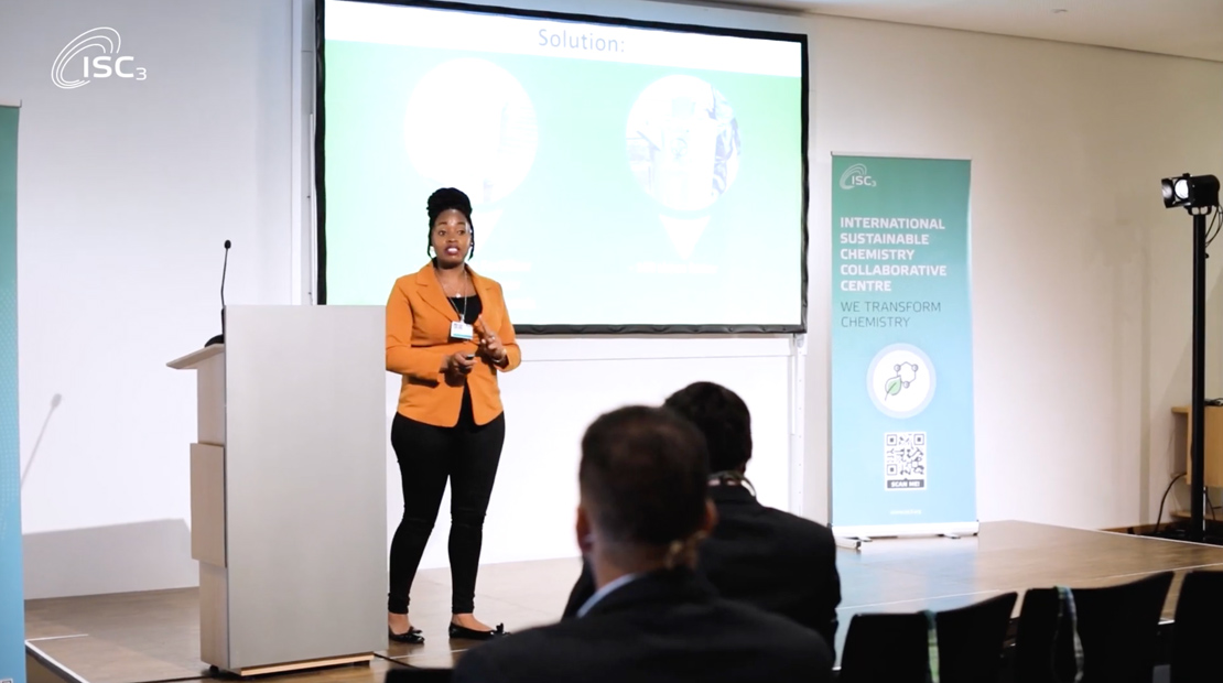 Woman presenting on front of audience