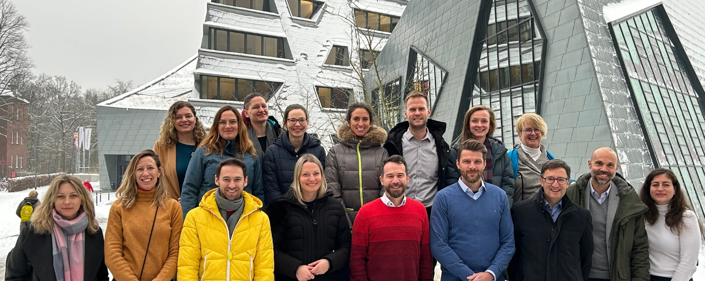 Group picture of the ISC3 team in front of Leuphana University in the snow.